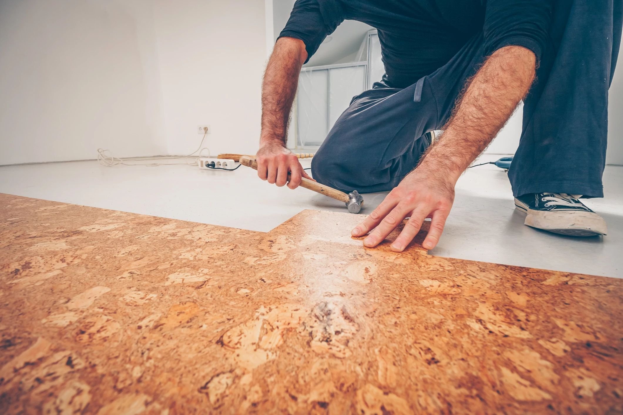 Person installing cork flooring from Essex Paint and Carpet in the Essex Junction, VT area