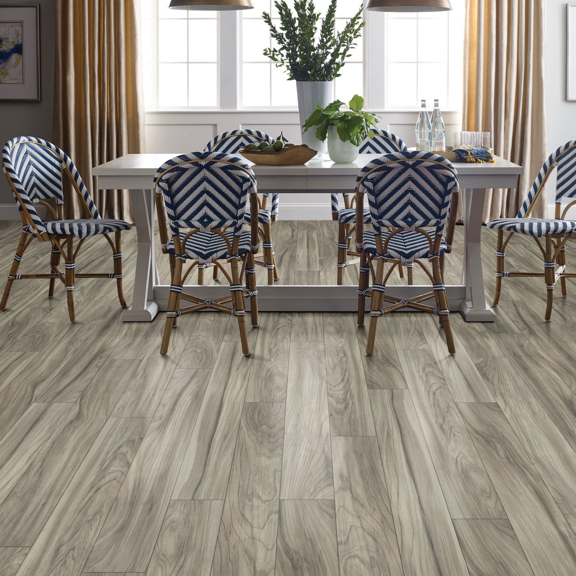 woven blue dining chairs around a dining table on laminate floor - Essex Paint and Carpet